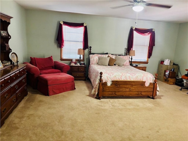 bedroom with light carpet and a ceiling fan