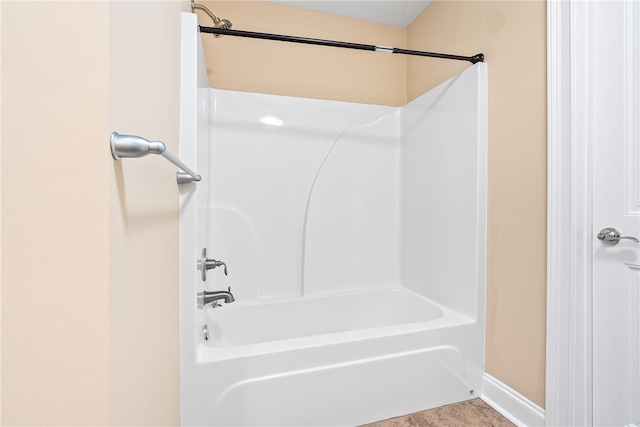 full bath featuring shower / bath combination and baseboards