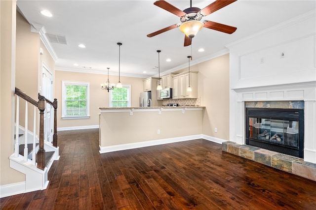 unfurnished living room featuring dark wood-style flooring, baseboards, recessed lighting, ceiling fan, and ornamental molding