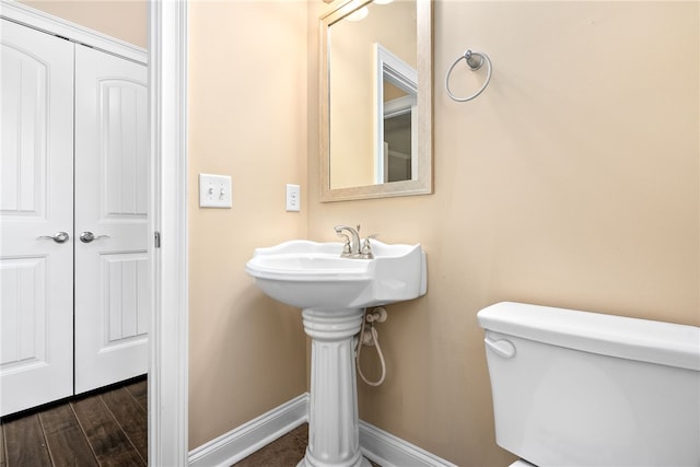 bathroom featuring baseboards, toilet, and wood finished floors