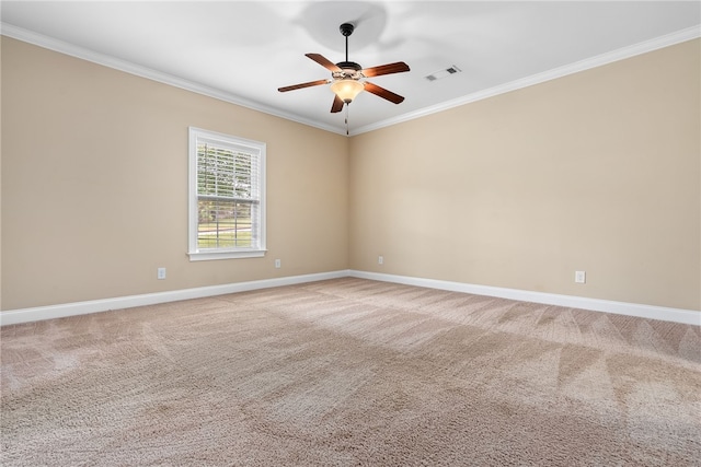 carpeted empty room featuring visible vents, a ceiling fan, baseboards, and crown molding