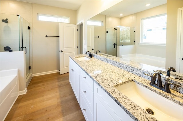 bathroom featuring hardwood / wood-style floors, vanity, and independent shower and bath