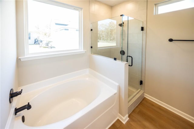 bathroom with separate shower and tub and wood-type flooring