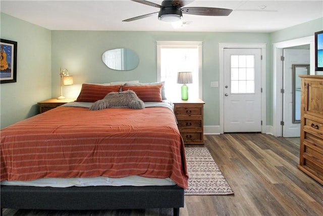 bedroom with baseboards, wood finished floors, and a ceiling fan