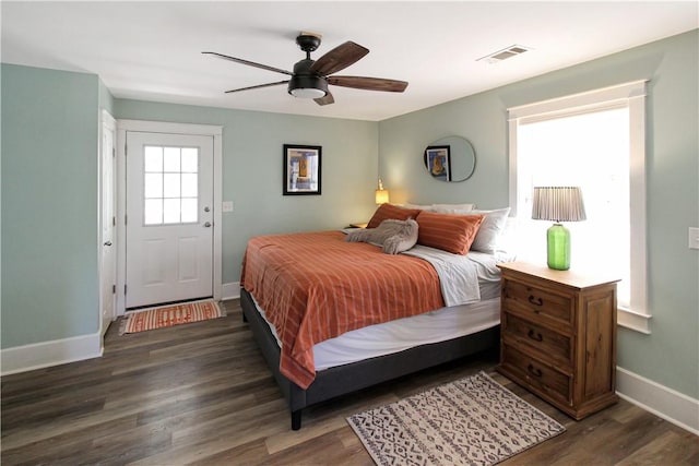 bedroom with wood finished floors, baseboards, ceiling fan, and visible vents