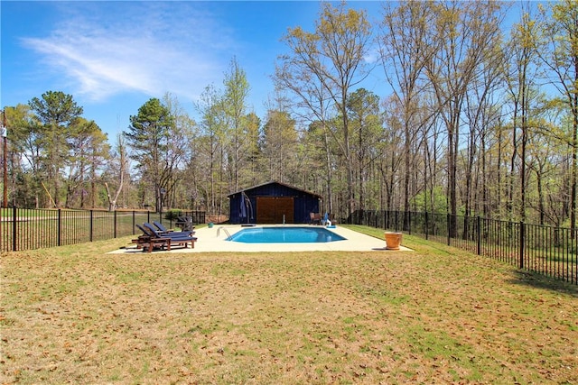 view of swimming pool featuring an outdoor structure, a patio, a fenced backyard, a fenced in pool, and a yard
