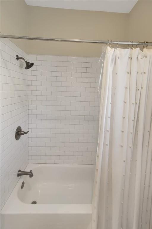 bathroom with shower / tub combo with curtain