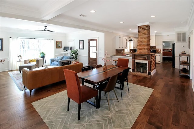 dining space featuring visible vents, ceiling fan, and dark wood-style flooring