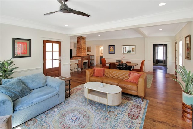 living area featuring crown molding, wood finished floors, recessed lighting, and a ceiling fan