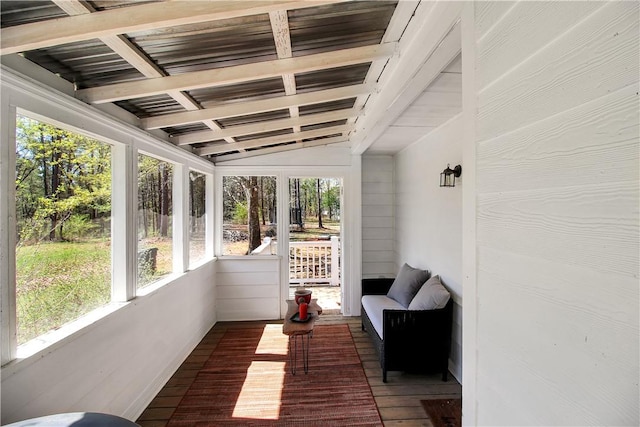 sunroom with plenty of natural light and beamed ceiling