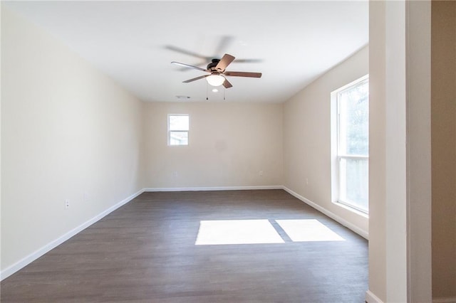 unfurnished room featuring baseboards, a ceiling fan, and wood finished floors