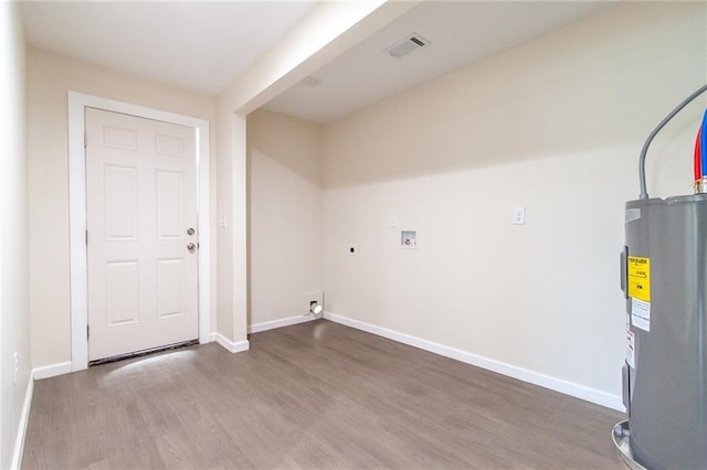 clothes washing area featuring water heater, visible vents, laundry area, hookup for a washing machine, and wood finished floors