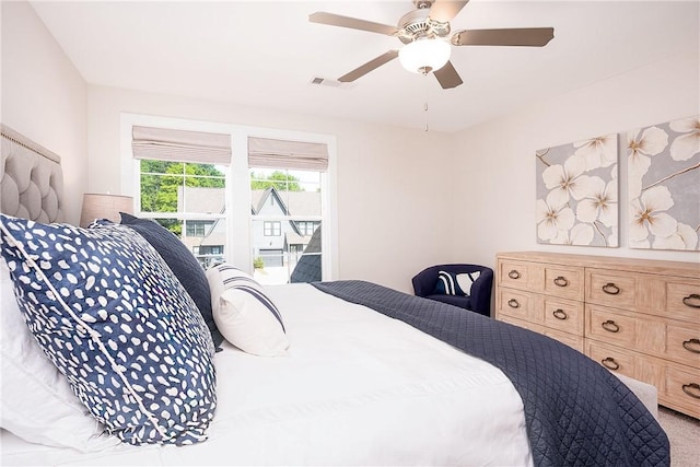 bedroom with carpet flooring, visible vents, and ceiling fan