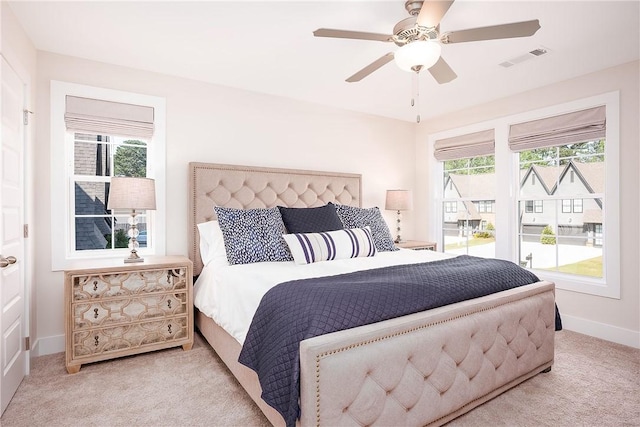 bedroom featuring visible vents, baseboards, a ceiling fan, and carpet flooring