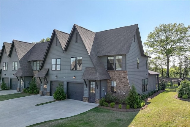 view of property featuring concrete driveway, a front lawn, stone siding, a shingled roof, and an attached garage