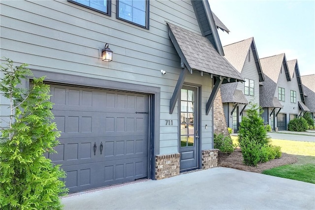 view of home's exterior featuring stone siding, a shingled roof, and a garage