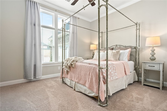 carpeted bedroom featuring baseboards, ceiling fan, and crown molding