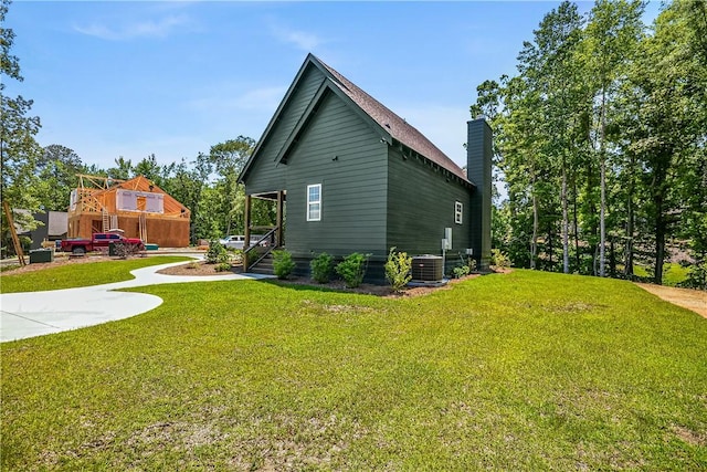 325 Whisper Trce, Tallassee, AL 36078 - view of side of home with a chimney and a lawn