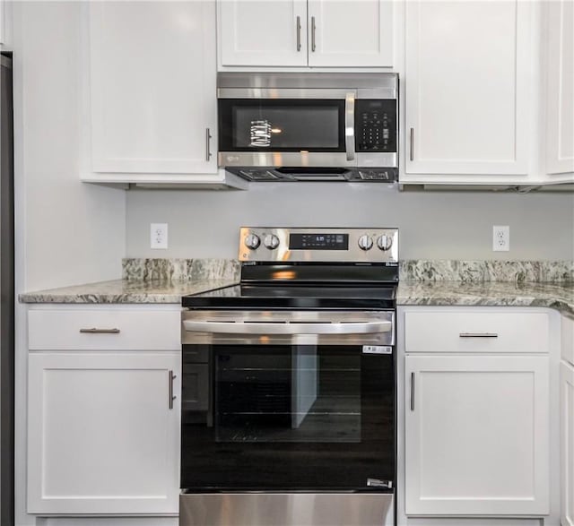 325 Whisper Trce, Tallassee, AL 36078 - kitchen with appliances with stainless steel finishes, white cabinets, and light stone counters