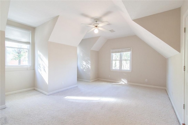 bonus room featuring ceiling fan, light colored carpet, and lofted ceiling