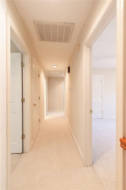 hallway featuring light carpet