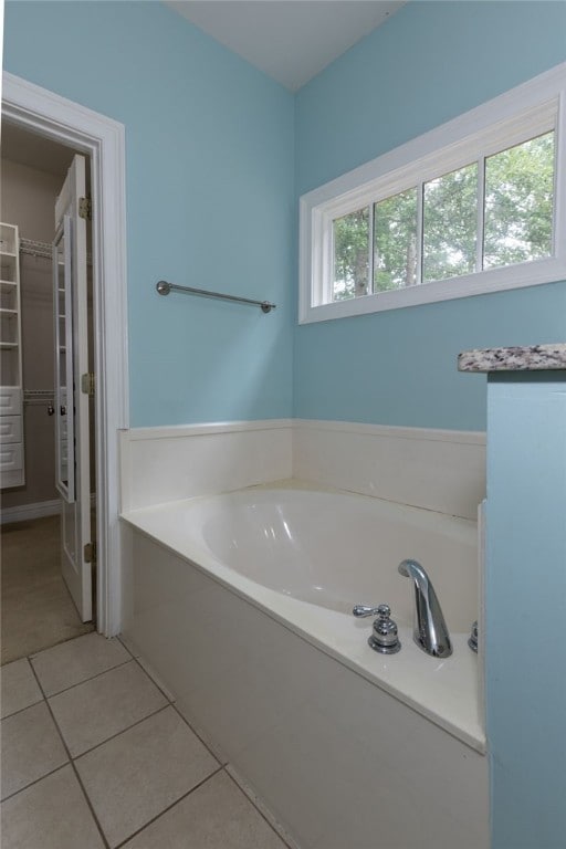 1761 Woodley Rd, Auburn, AL 36830 - bathroom with a garden tub, tile patterned floors, and a spacious closet