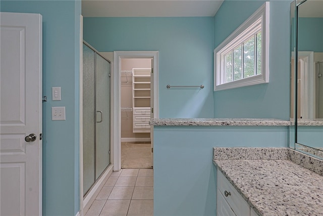 1761 Woodley Rd, Auburn, AL 36830 - bathroom with a stall shower, tile patterned floors, vanity, and a spacious closet