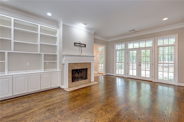 1761 Woodley Rd, Auburn, AL 36830 - unfurnished living room with ornamental molding, a tile fireplace, dark wood-style floors, built in shelves, and recessed lighting