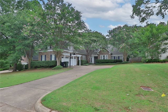 1761 Woodley Rd, Auburn, AL 36830 - view of front of property with concrete driveway, an attached garage, and brick siding