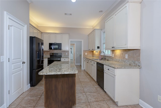 1761 Woodley Rd, Auburn, AL 36830 - kitchen with black appliances, a kitchen island, tasteful backsplash, light stone counters, and ornamental molding