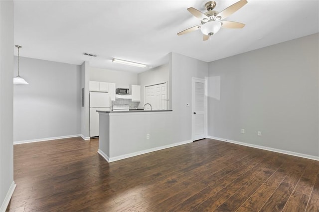 unfurnished living room featuring dark hardwood / wood-style flooring and ceiling fan