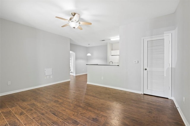 unfurnished room featuring ceiling fan and dark hardwood / wood-style flooring