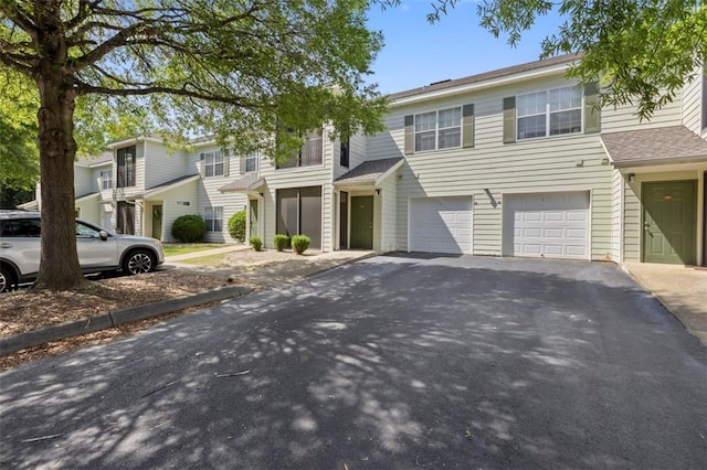 multi unit property featuring a garage