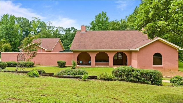 1115 Willow Run, Opelika, AL 36801 - rear view of house with a lawn, stucco siding, a chimney, a porch, and a shingled roof