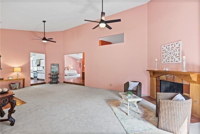 1115 Willow Run, Opelika, AL 36801 - carpeted living room featuring a ceiling fan, a tiled fireplace, and high vaulted ceiling