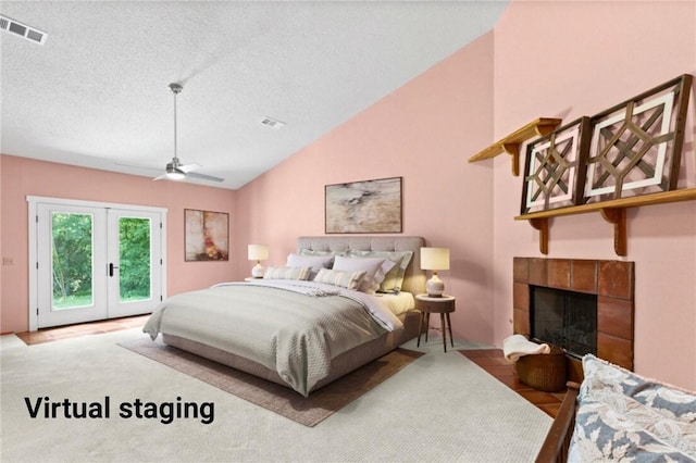 1115 Willow Run, Opelika, AL 36801 - carpeted bedroom featuring access to outside, lofted ceiling, french doors, a textured ceiling, and a tiled fireplace