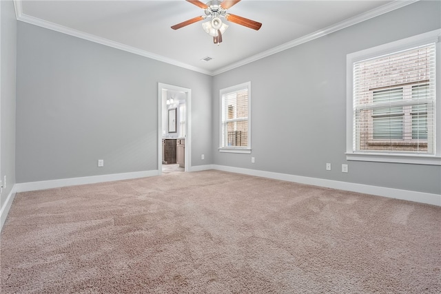 carpeted spare room with crown molding and ceiling fan