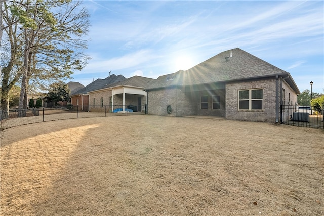 rear view of property featuring central AC unit