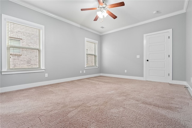 carpeted spare room with ceiling fan and ornamental molding