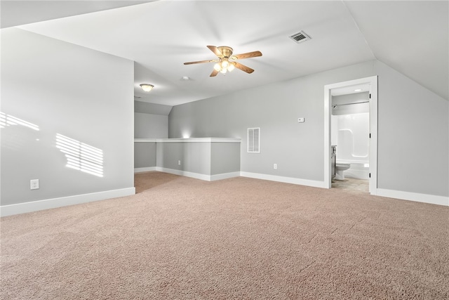 interior space with vaulted ceiling, ceiling fan, and carpet flooring