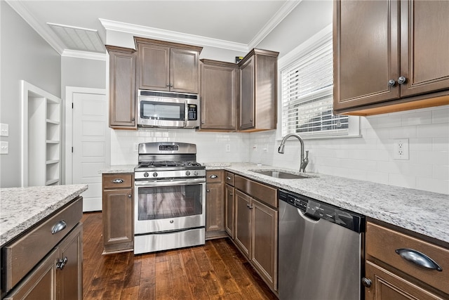 kitchen featuring sink, crown molding, appliances with stainless steel finishes, dark hardwood / wood-style floors, and light stone counters