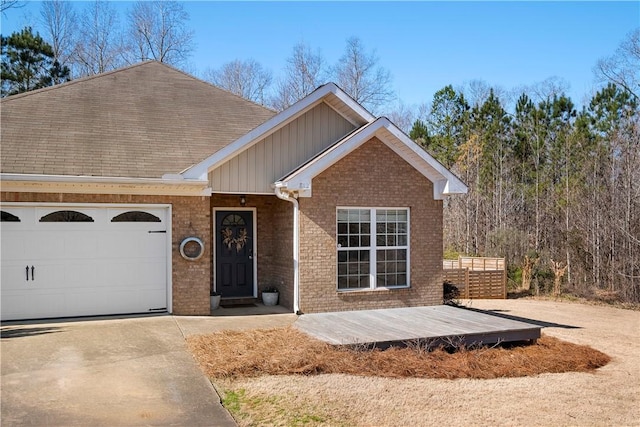 view of front facade featuring brick siding, board and batten siding, concrete driveway, a deck, and a garage