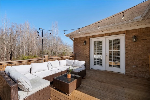 wooden terrace with french doors and an outdoor hangout area