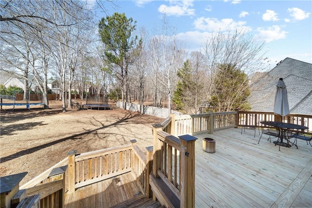 wooden deck featuring a trampoline