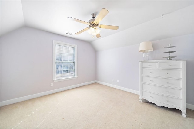 additional living space with vaulted ceiling, light carpet, and ceiling fan