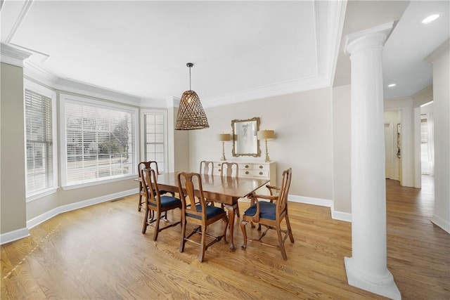 dining area with crown molding, light hardwood / wood-style floors, and ornate columns