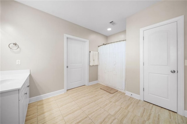 bathroom with vanity and a shower with shower curtain