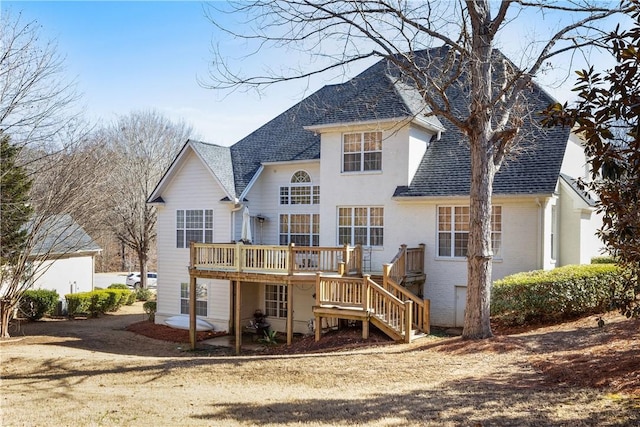 rear view of house with a wooden deck