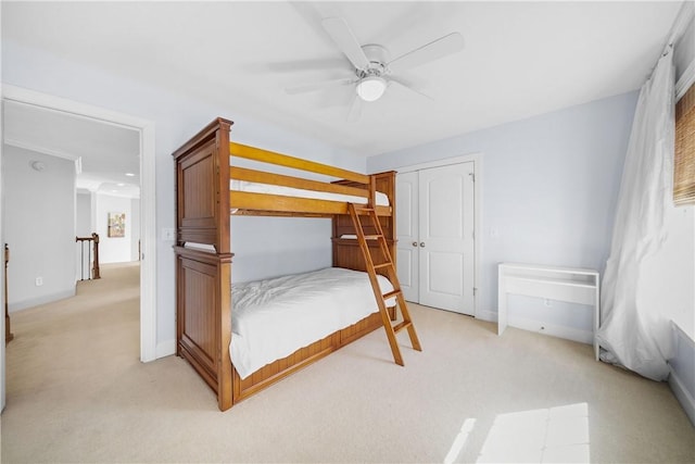 bedroom featuring light colored carpet and ceiling fan