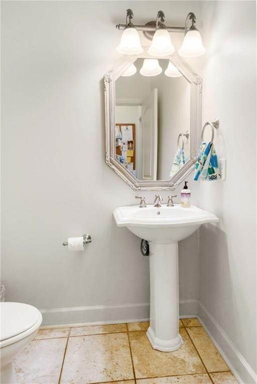 bathroom with toilet and tile patterned flooring